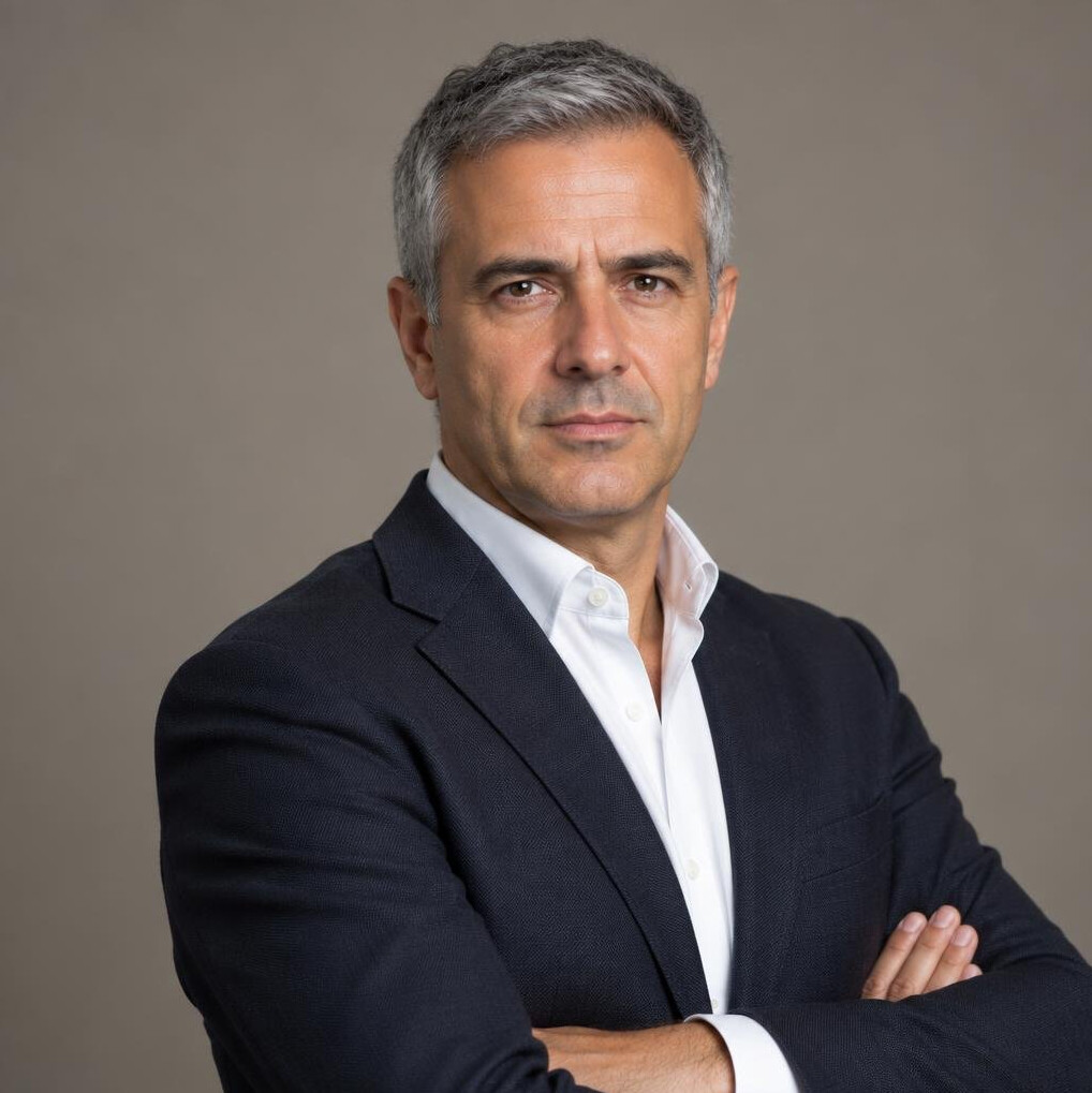 Portrait of a Portuguese male journalist in his 40s wearing a blazer